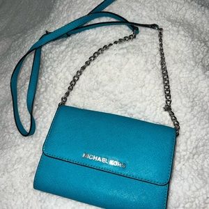 Michael Kors turquoise crossbody bag.